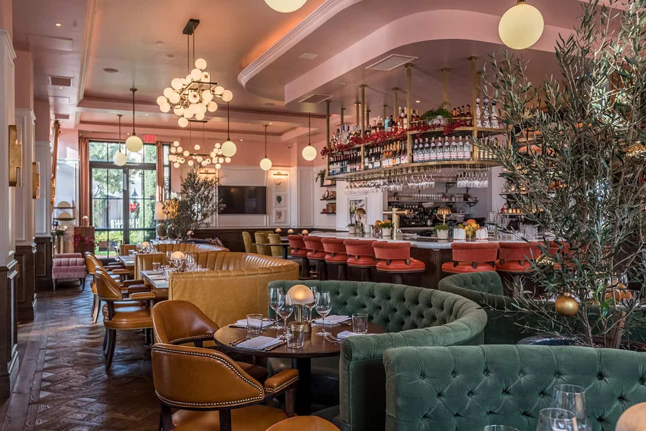 Dining room view towards the marble bar with coral stools at The Draycott by Fettle