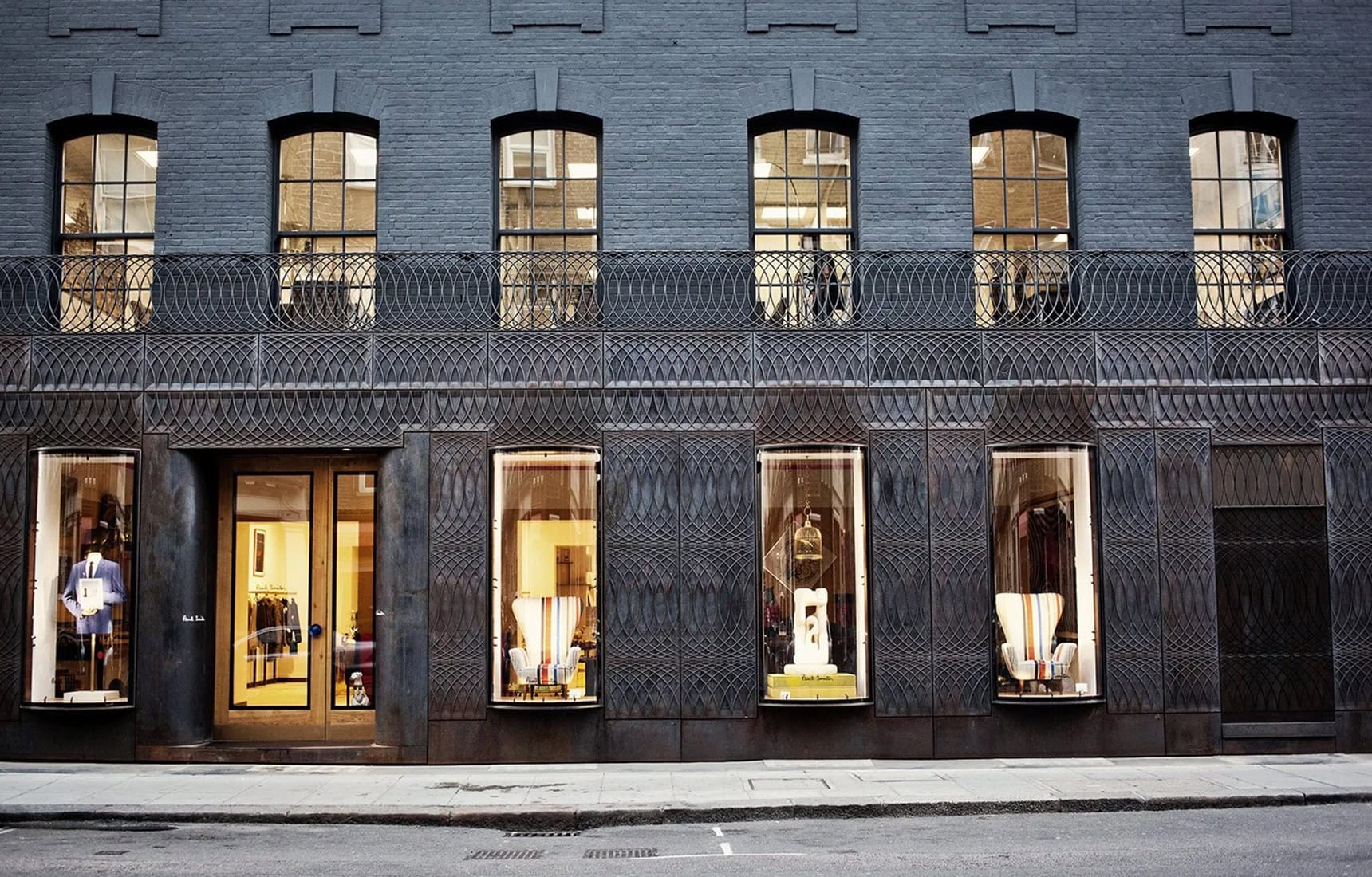The cast-iron facade of Paul Smith’s No. 9 Albemarle Street store lit at night