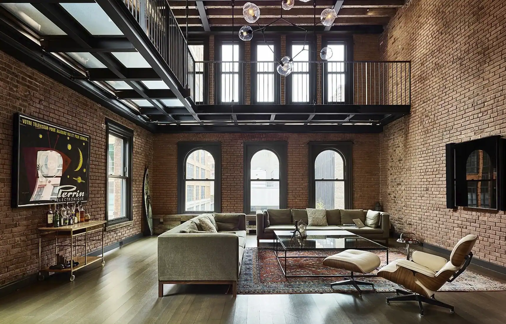 Restored interior of 10 Hubert Street TriBeCa by ODA New York — exposed brick walls and reclaimed timber beams in the main living space