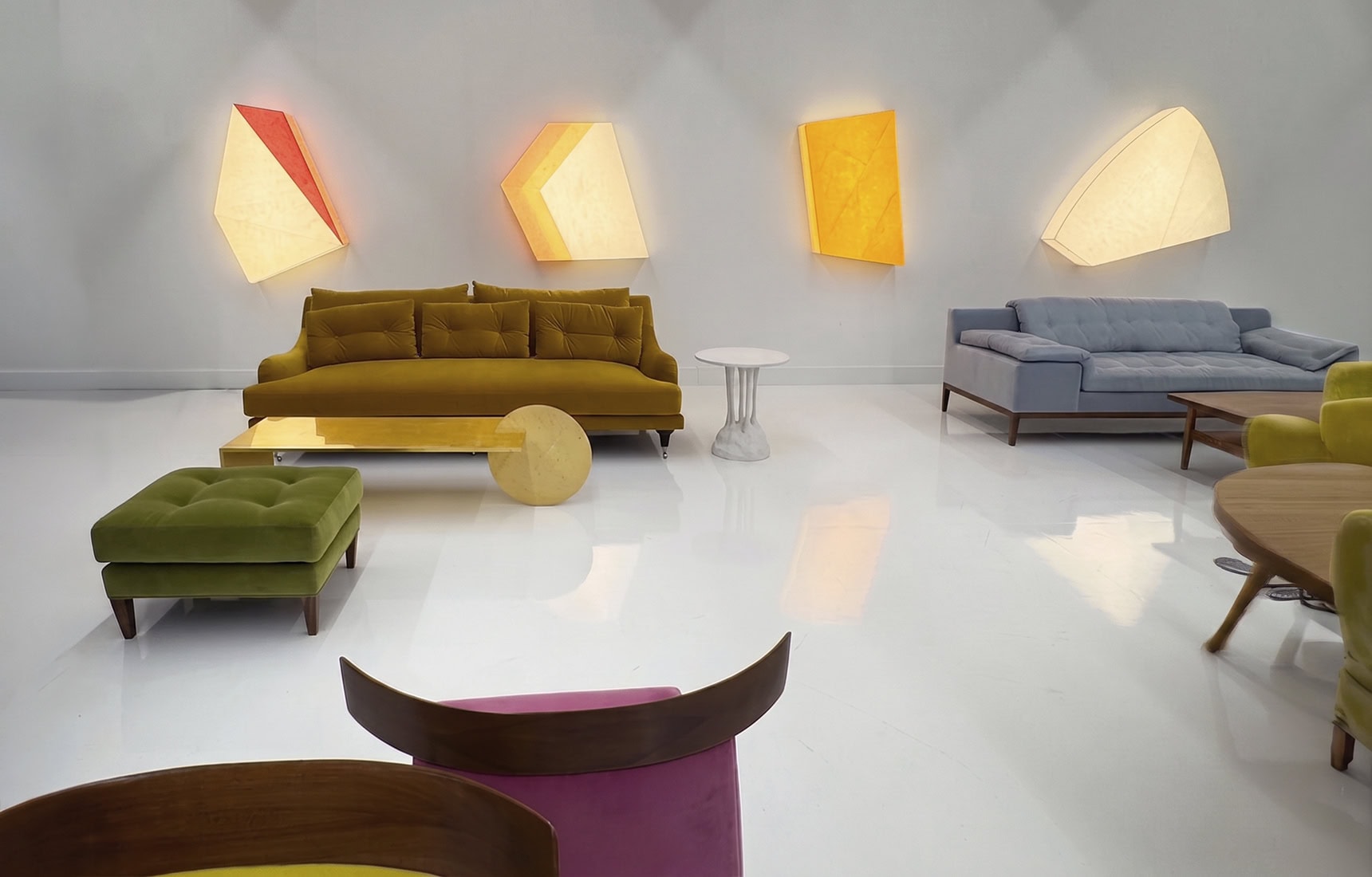 A showroom overview with sofas and colourful wall lights at the Ralph Pucci showroom in Wynwood, Miami