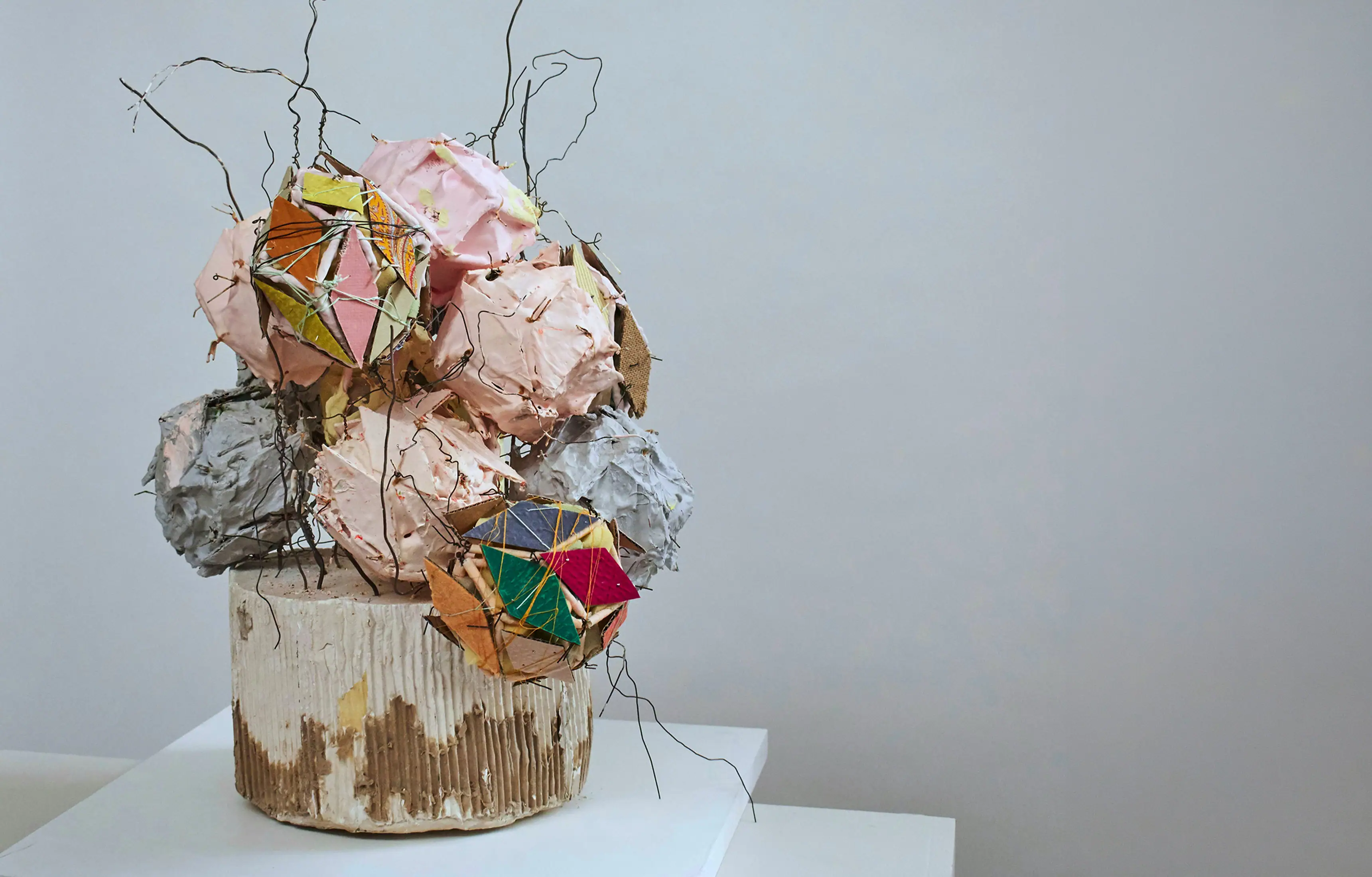 Amanda Benson's sculpture Couettes, crumpled pink and patterned forms above a scored ceramic base